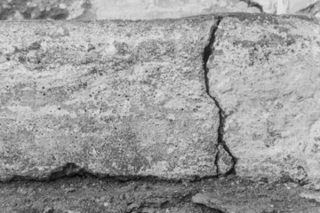 Crack on old dirty white concrete wall cement surface broken background damage texture
