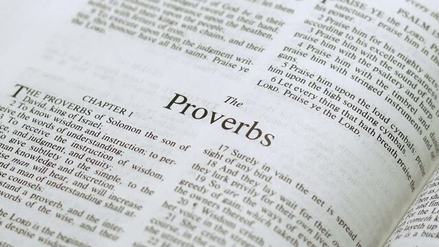 Close Up Shot of  Bible Page Turning to the book of Proverbs