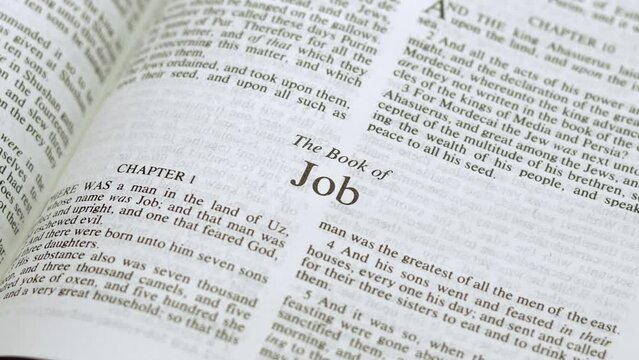 Close Up Shot of  Bible Page Turning to the book of Job