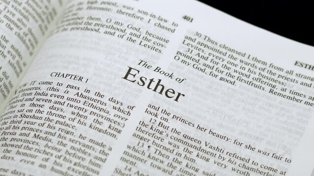Close Up Shot of  Bible Page Turning to the book of Esther