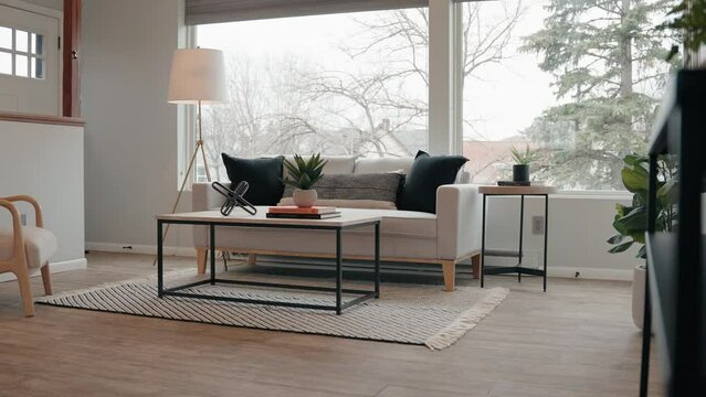 couch in the living room of a tiny home with a large window