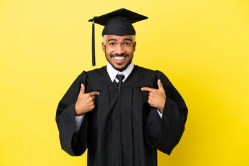 Young university graduate Colombian man isolated on yellow background with surprise facial expression