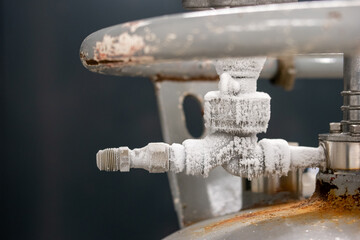 Frozen liquid nitrogen storage tank transfer valve. Close up shot, no people