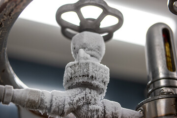 Frozen liquid nitrogen storage tank transfer valve. Close up shot, no people