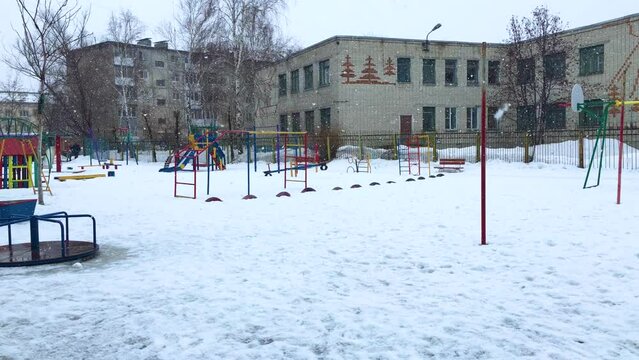 big beautiful snowflakes are spinning and flying near the playground