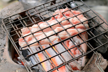 Barbecue pork Toast grill or Pork steak toasted for cooking. Thai food, Street food.Pork satay grilling on stove or Thai style roasted pork at the market.