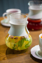 Two women discuss business projects in a cafe over hot lemonade or herbal tea. coffee shop or restaurant concept 