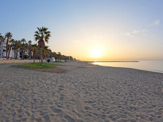 La Malagueta urban sand beach at sunset golden light on the Costa del Sol, Malaga city center,...