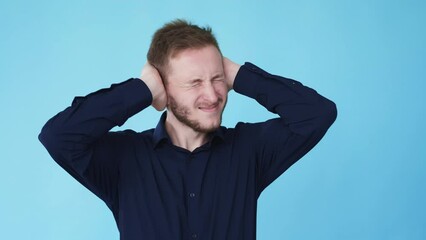 Migraine pain. Stress problem. Listen refusal. Boomerang motion. Suffering frustrated man holding head in headache covering ears isolated on blue background GIF loop animation.