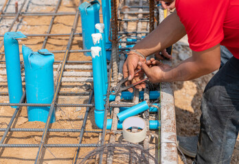 Workers tie the water supply system to the foundation