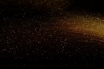 background of abstract glitter lights. gold and black. de focused