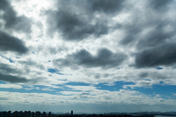 Fototapeta na wymiar Dark clouds over city buidlings