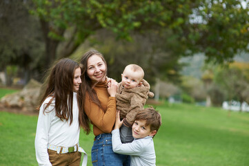 mother with children on a walk in the park together