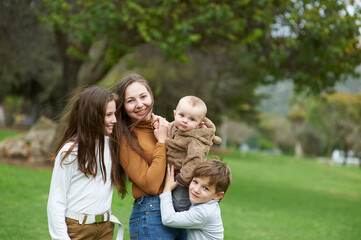 mother with children on a walk in the park together