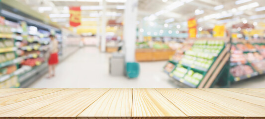 Wood table top with supermarket grocery store blurred defocused background with bokeh light for product display