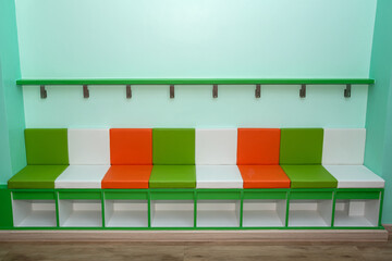 Colorful bench for kindergarten children, under the bench there is also a shoe storage box.