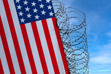 national flag of USA on concrete wall, barbed wire fence, concept of prison, symbol of police...