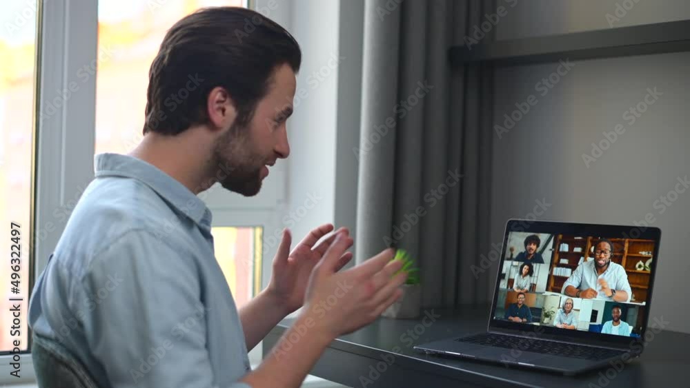 Wall mural Caucasian man using laptop for video connection with friends. Man talking with young people on the screen. Video chatting concept. 4K footage