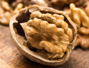Half of a walnut on a wooden table.