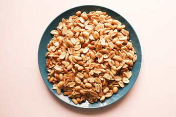 Processed pea nuts in a bowl on table top down .