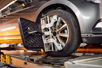 Diagnostics and configuration collapse-convergence. Car Wheels alignment equipment on stand in a...