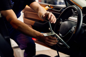 Аuto mechanic sets the car for diagnostics and configuration collapse-convergence. Car Wheels alignment equipment on stand in a repair station.