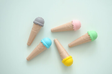 toy ice cream of different colors on a colored background 