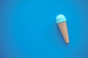 toy ice cream of different colors on a colored background 