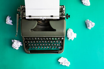 Vintage typewriter and crumpled paper sheets. Writer and blogger concept. Top view, flat lay