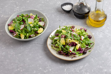 Fresh green vegan salad from green leaves mix and vegetables. Top view