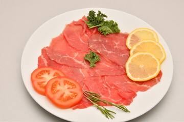 Carpaccio dish of thinly sliced pieces (slices) raw beef tenderloin 