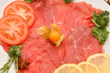 Carpaccio dish of thinly sliced pieces (slices) raw beef tenderloin 