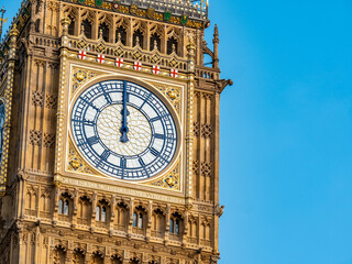 Big Ben at midday. Close detail of the face to the iconic London landmark clock tower at exactly 12 o'clock mid day. - 496328878