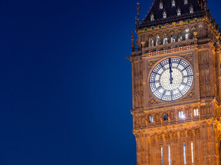 Big Ben at midnight. The iconic London landmark clock tower at exactly 12 o'clock; illuminated and...