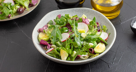 Green vegan salad from green leaves mix and vegetables. Top view
