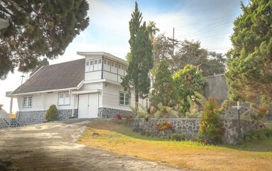 a villa with an old building design surrounded by big trees