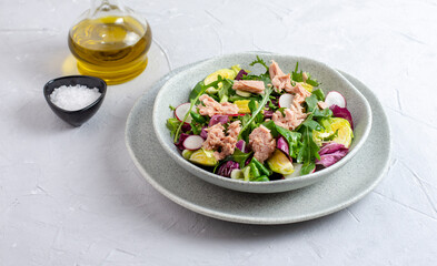 Tuna salad with lettuce, spring onions, brussels sprout, cabbage, arugula, radish and canned tuna. Vitamin salad. Close up.