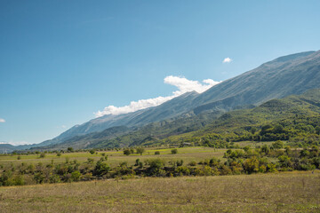 Obraz premium Beautiful mountain valley with gentle hills and agricultutal filds