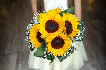  bouquet di girasoli  tenuto in mano da una sposa 