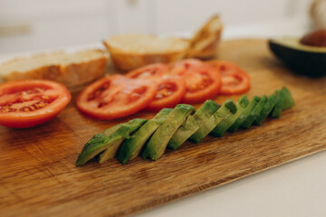 toast with avocado in the kitchen. Cooking breakfast