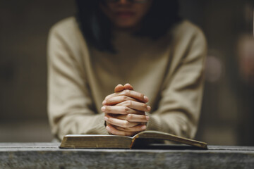 Christian life crisis prayer to god. Woman holding hands pray for god blessing to wishing have a better life on a wooden table. Woman hands praying to god with the bible. believe in goodness. - obrazy, fototapety, plakaty