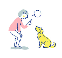 犬にコマンドを言っている若い女性