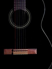 black guitar with colored strings