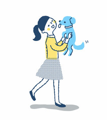犬を抱き上げる笑顔の女性