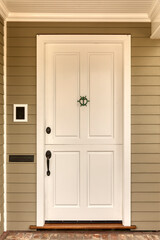 Obraz na płótnie Canvas Front door, white front door of a house with a door knocker