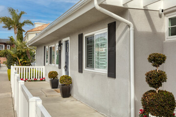 white house in the village with a white picket fence and a front porch