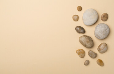 Set of sea stones on color background, top view