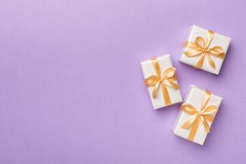White gift boxes on color background, top view