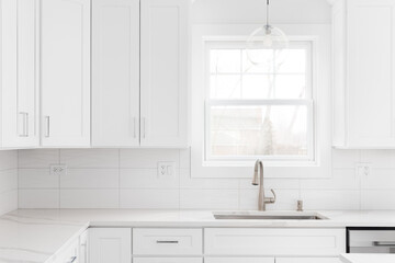 A kitchen detail shot with white cabinets, wavy subway tile backsplash, and a glass pendant light...