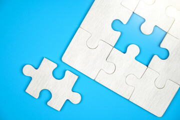 The last piece of jigsaw puzzle. on a blue background.